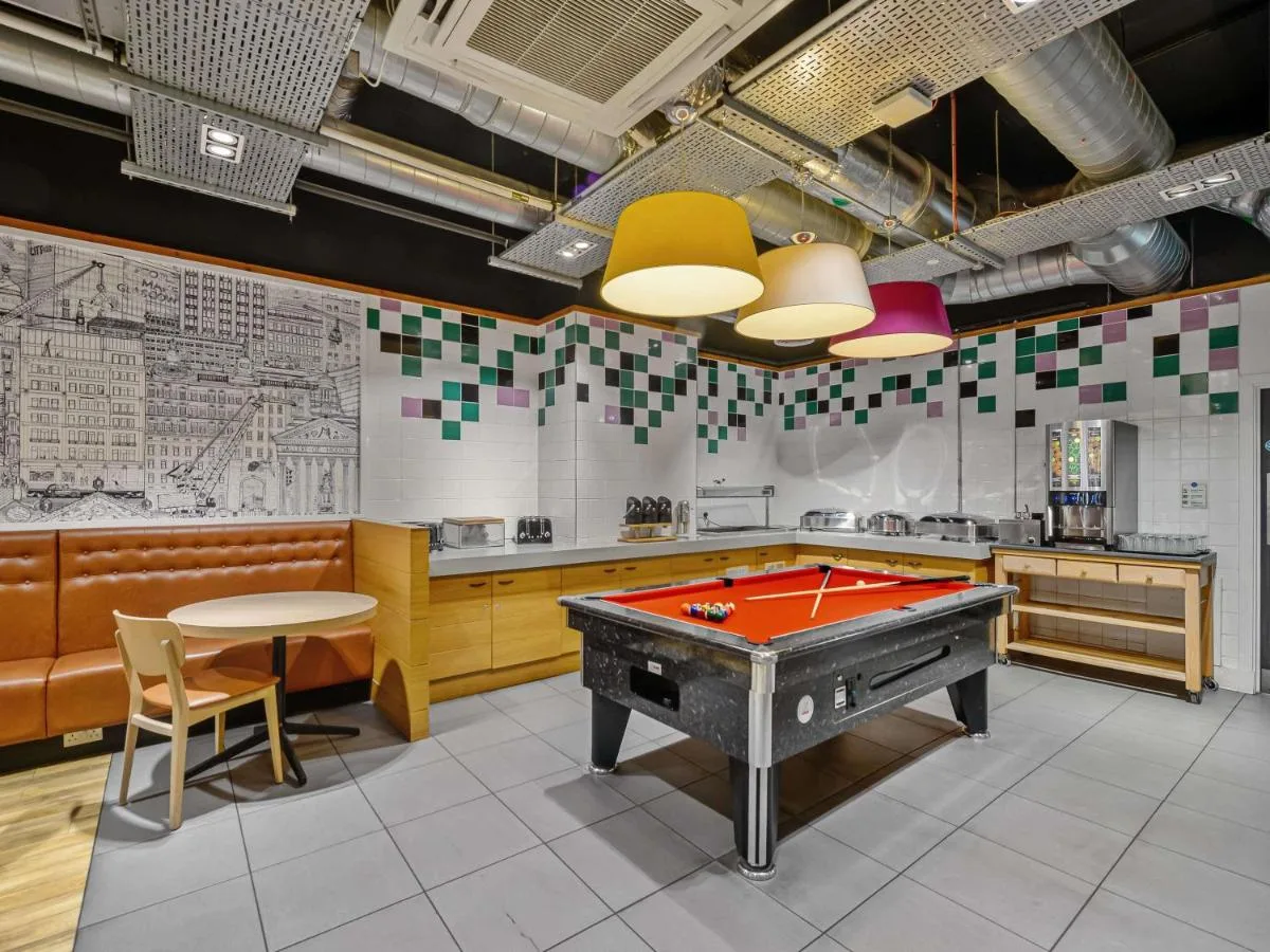 a kitchen with a pool table in a room at ibis Styles Glasgow Centre George Square in Glasgow